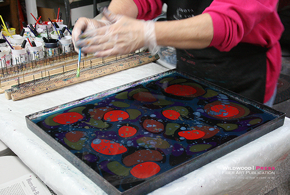 Mary Holland demonstrating paper marbling